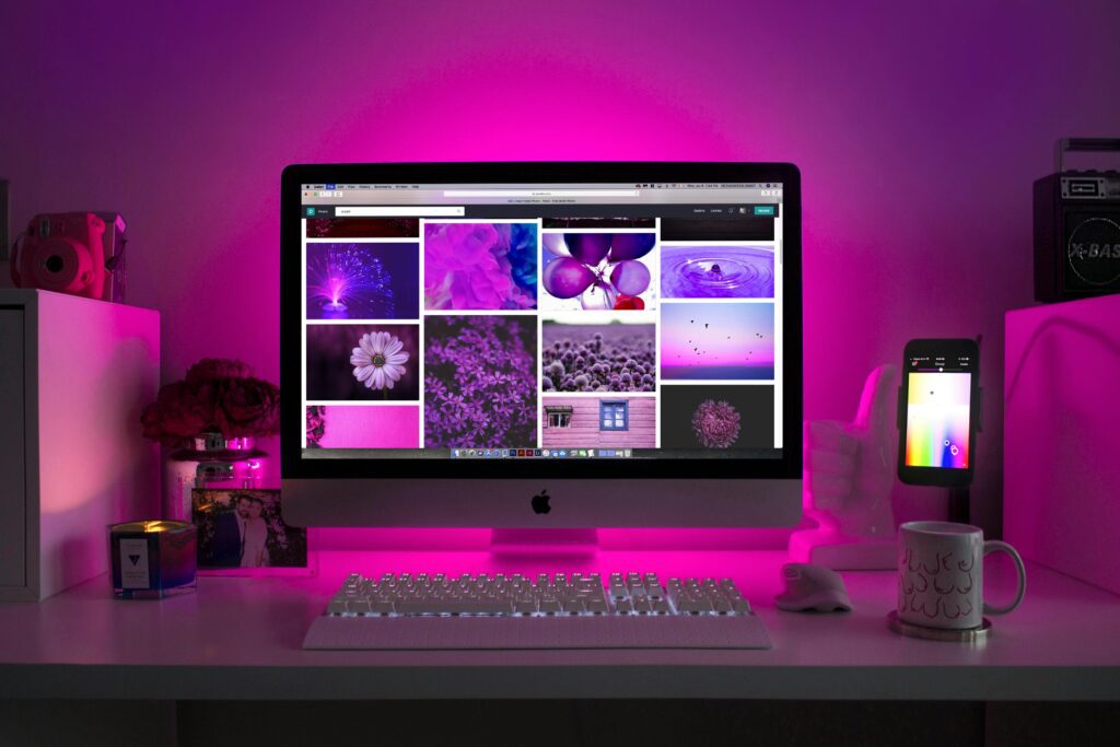 pexels photo 1779487 1779487 Modern desk setup with neon lighting and a desktop computer displaying colorful images.